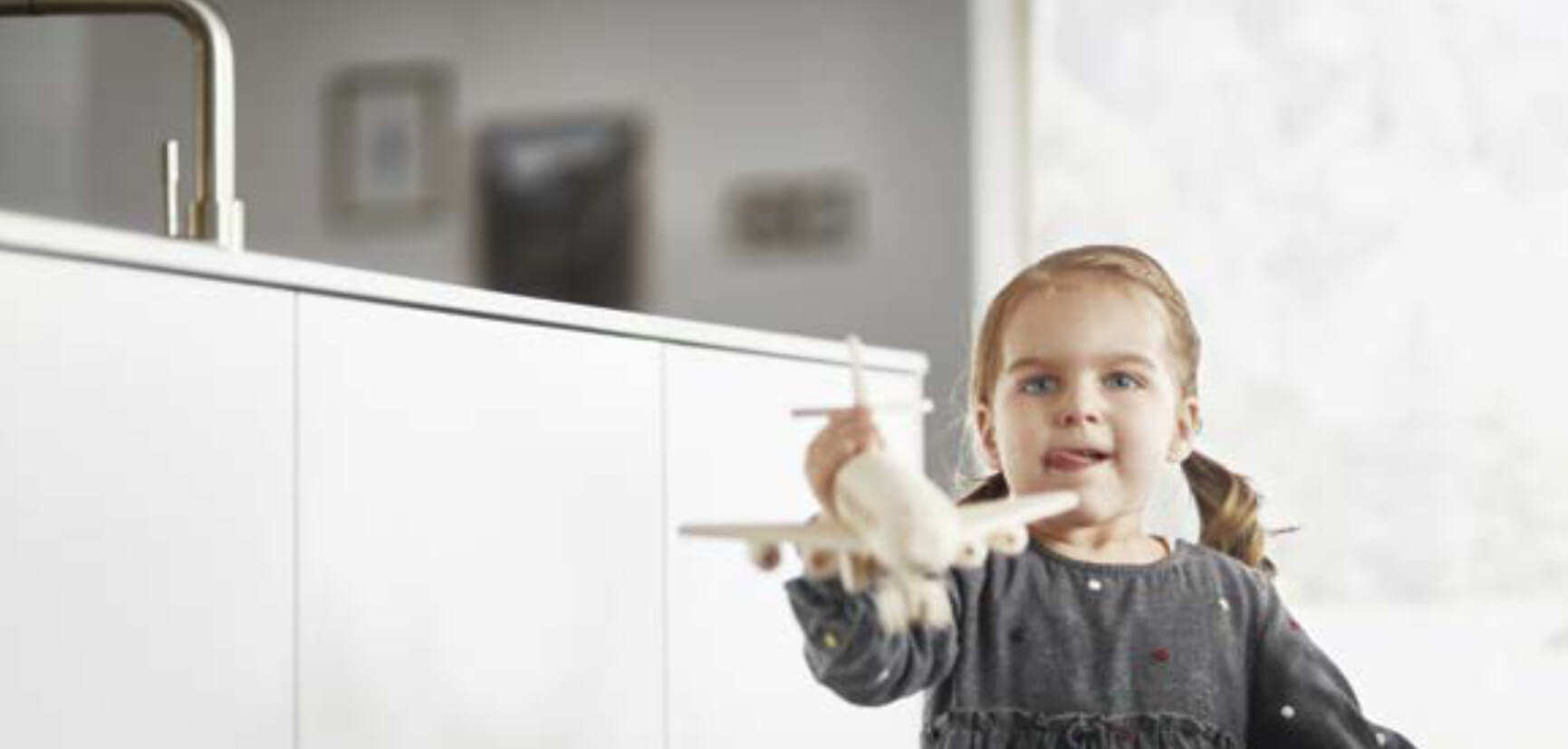 Girl playing in kitchen